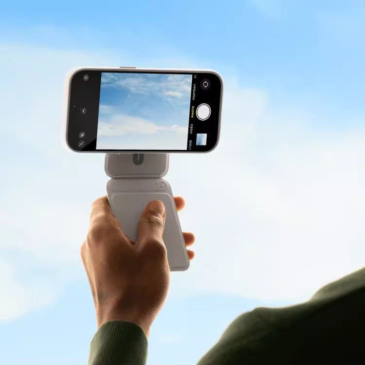 Multifunctional Magnetic Mobile Phone Holder Mobile Phone Case in blue supports a smartphone in camera mode on a desk setup. Ideal for hands-free use and photography.