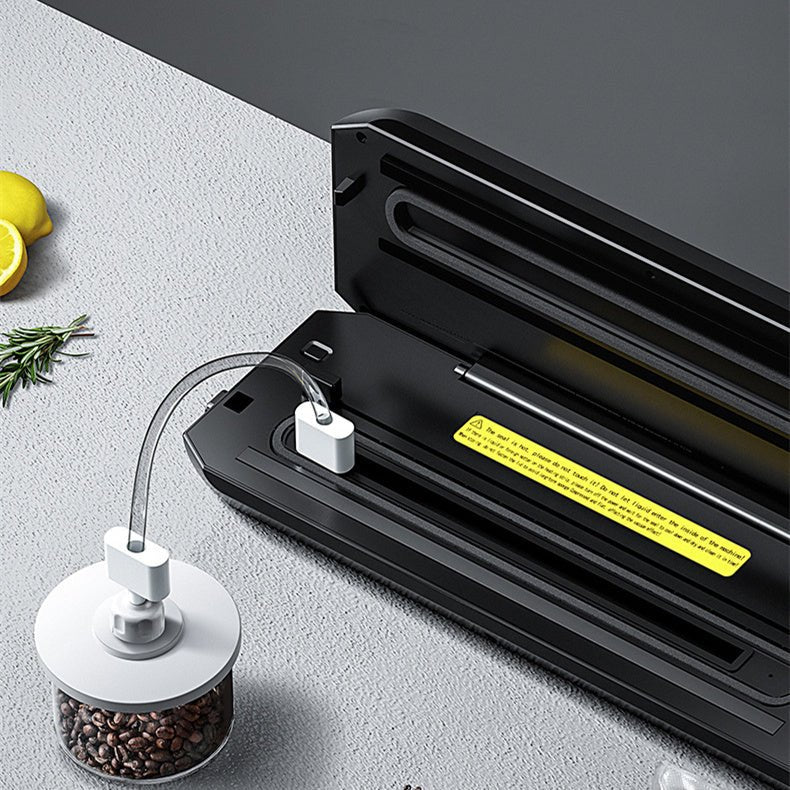Home Vacuum Sealer Food Sealer sealing fresh salmon in vacuum bag on kitchen counter. Compact HP-9007 model with digital controls for food preservation.