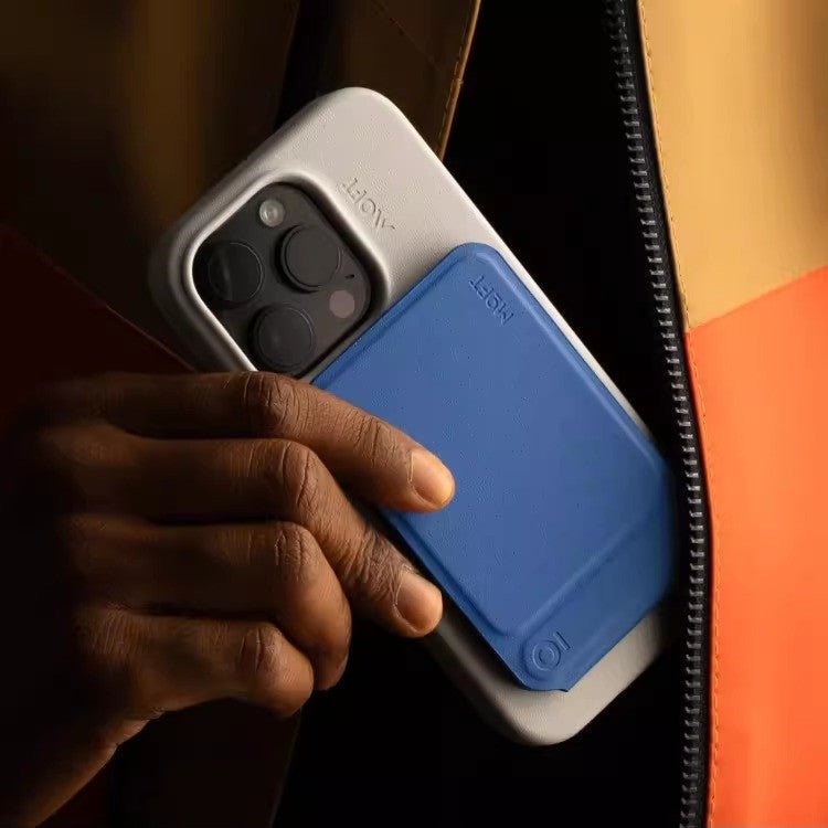 Multifunctional Magnetic Mobile Phone Holder Mobile Phone Case in blue supports a smartphone in camera mode on a desk setup. Ideal for hands-free use and photography.