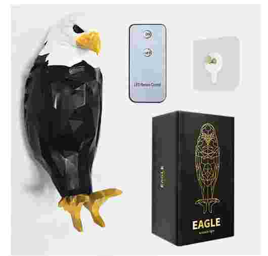 Injection molding owl eagle night light mounted above bed, casting wing-shaped light patterns on dark wall. Modern wall decor for gaming rooms.