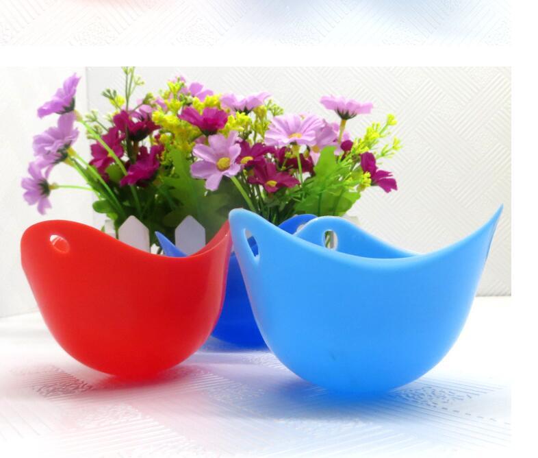 Green Silicone Egg Cooker 4 Color Silicone Egg Cooker set with eggs cooking in colorful silicone cups in a frying pan. Heat-resistant, non-stick kitchen tool.