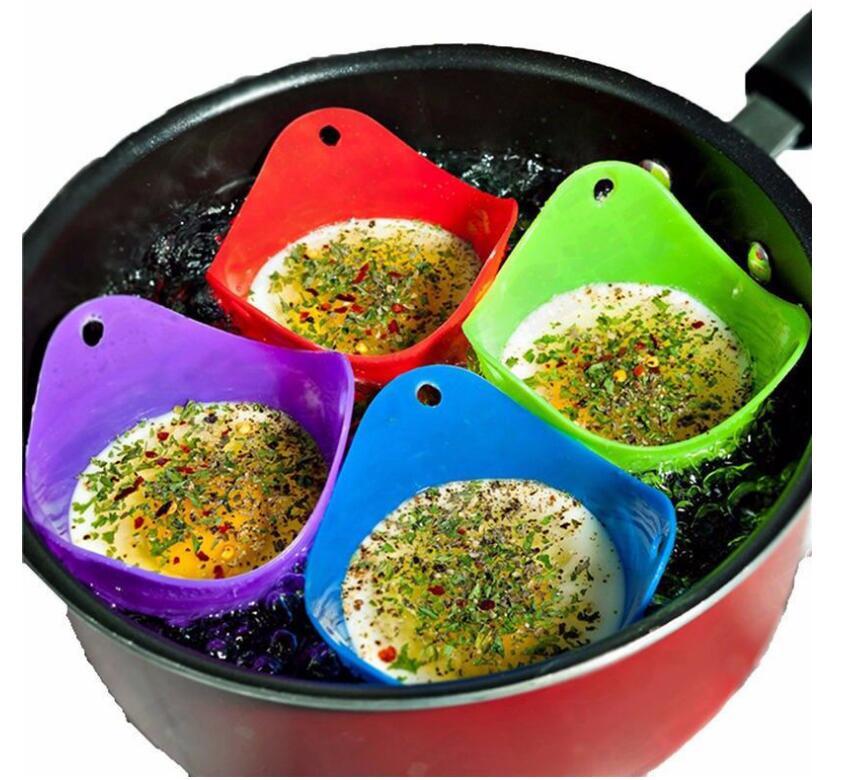 Green Silicone Egg Cooker 4 Color Silicone Egg Cooker set with eggs cooking in colorful silicone cups in a frying pan. Heat-resistant, non-stick kitchen tool.