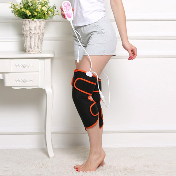 Warm heat electric heating knee protector leg vibration massager worn by woman sitting on floor. Multi-function joint massage device for legs.