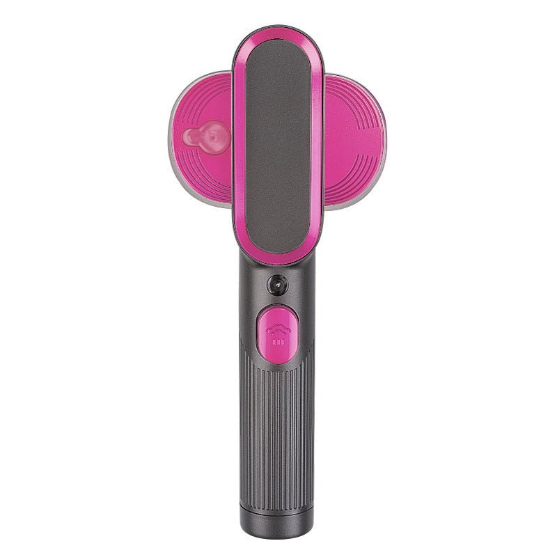 Household Small Portable Steamer  in black and pink used to steam a beige blazer sleeve. Compact vacuum steamer ideal for home use.