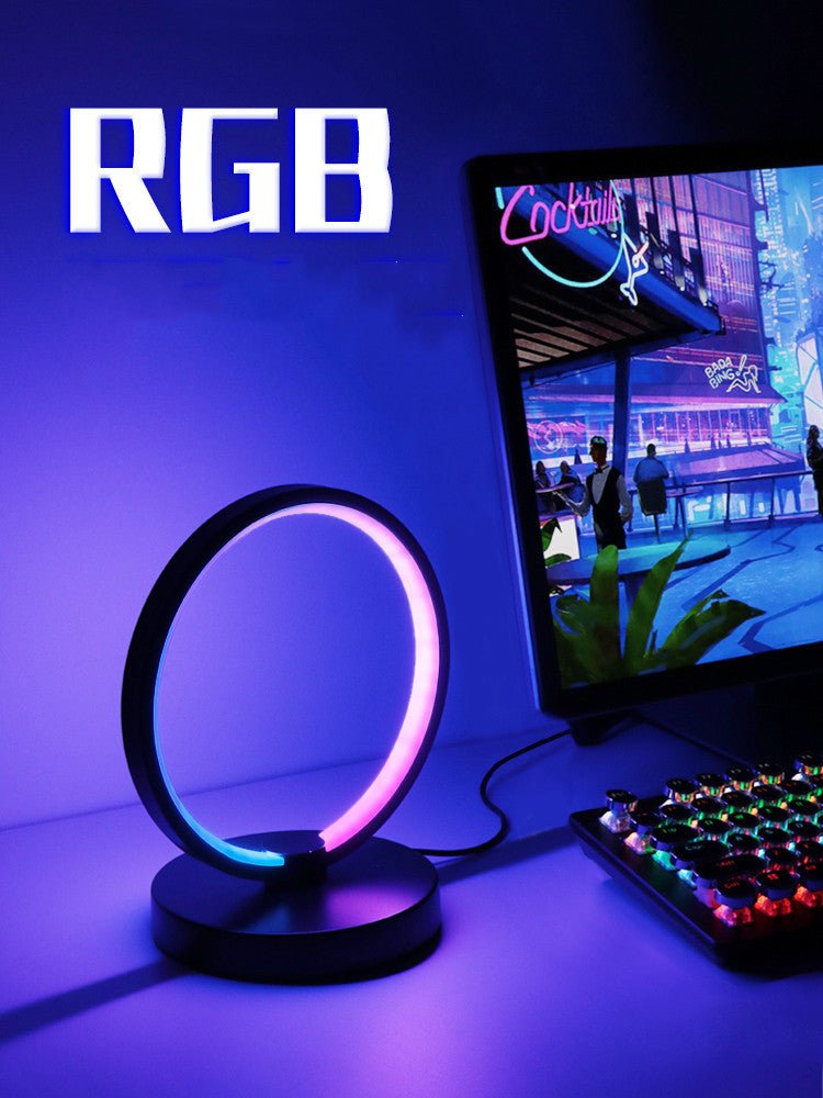 RGB atmosphere desk lamp with circular aluminum frame and intelligent remote control on gaming desk setup