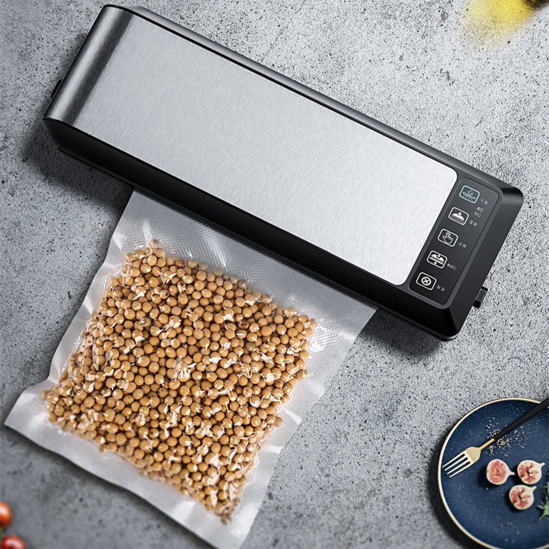 Home Vacuum Sealer Food Sealer sealing fresh salmon in vacuum bag on kitchen counter. Compact HP-9007 model with digital controls for food preservation.