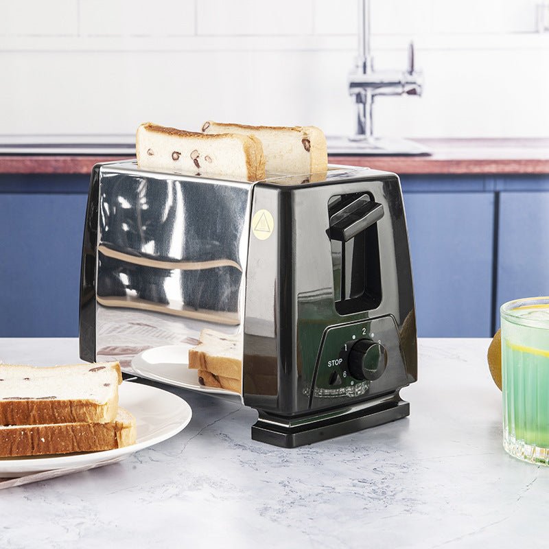 Compact black stainless steel toaster with buttons, toasting bread slices in a modern kitchen setting for home breakfast use