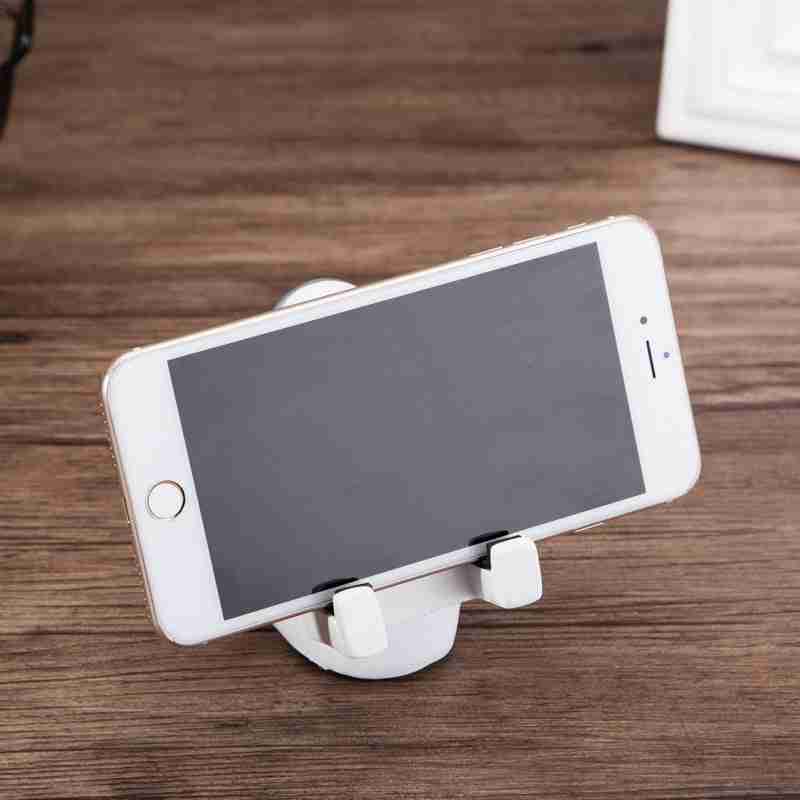 Astronaut Mobile Phone Stand Fun & Functional Desk Holder made of resin, featuring a seated astronaut figure holding a remote and supporting a smartphone.