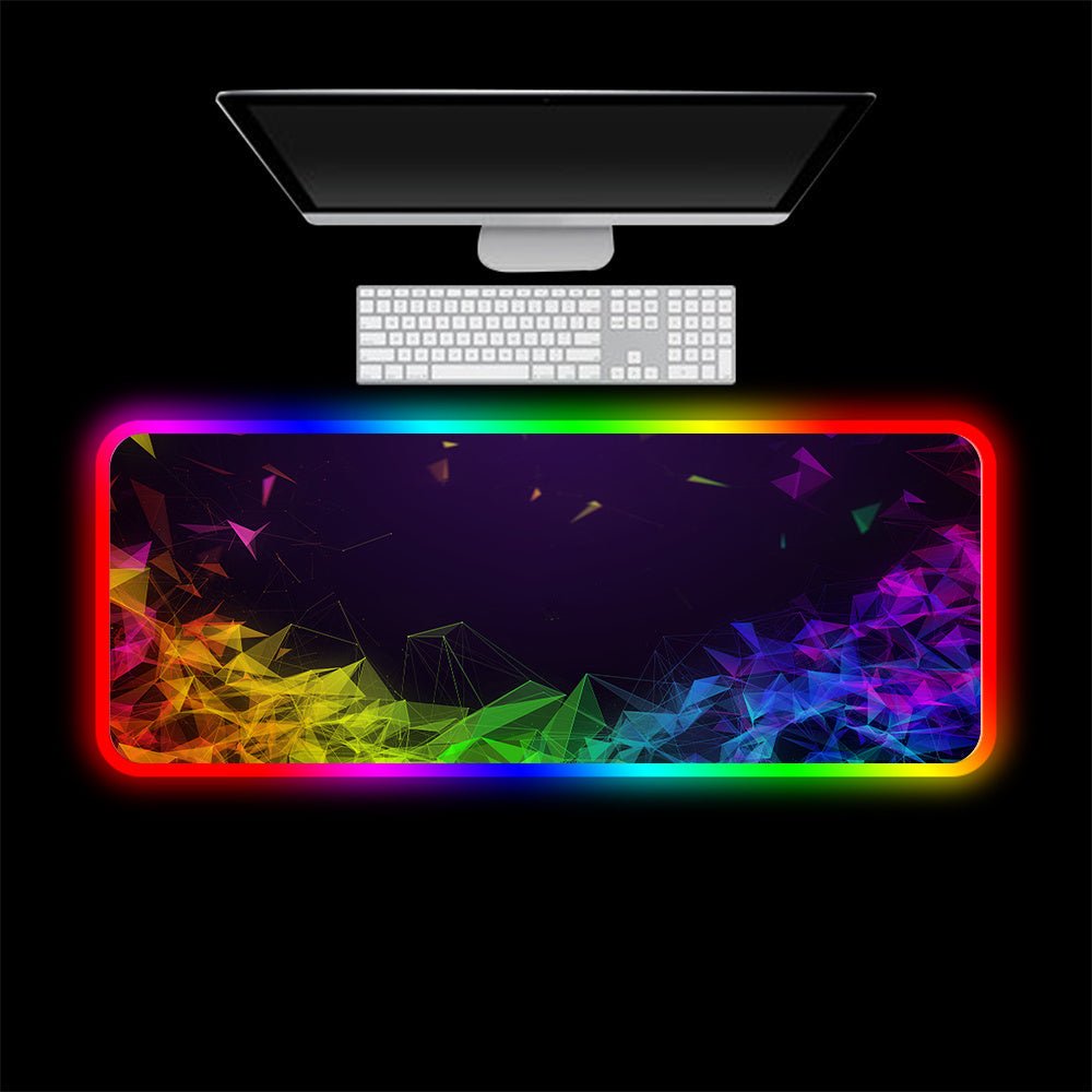 Luminous RGB gaming mouse pad with LED lights and colorful geometric design on large office desk