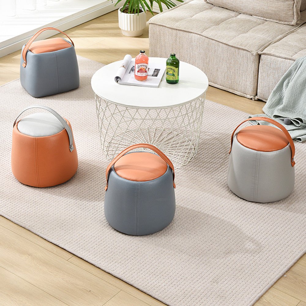 Set of modern small sofa stools with orange and gray tech fabric and handles around white coffee table in living room