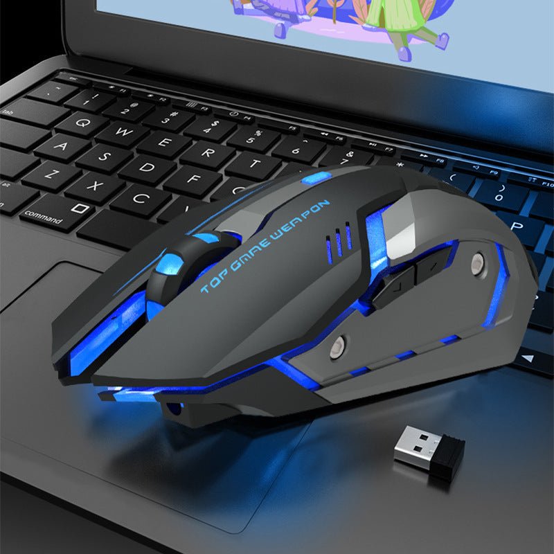 Wireless charging silent ergonomic gaming mouse with blue LED lights on laptop keyboard