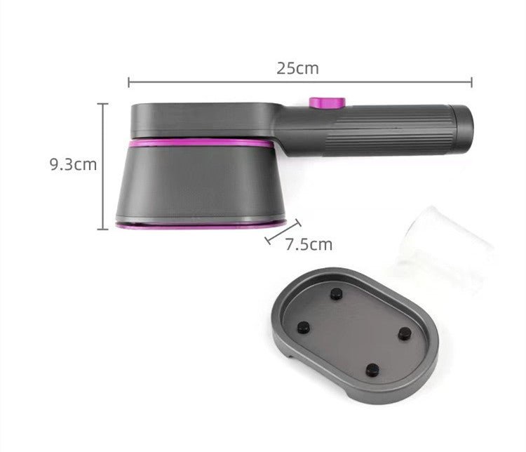 Household Small Portable Steamer  in black and pink used to steam a beige blazer sleeve. Compact vacuum steamer ideal for home use.